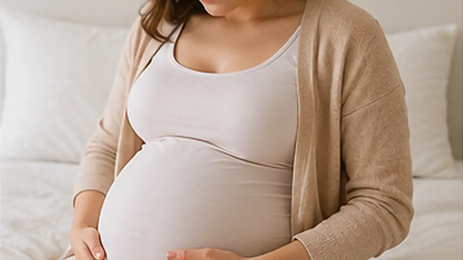 Realistic maternity and pregnancy hero image showing an expectant mother relaxing comfortably in a bright and peaceful bedroom.